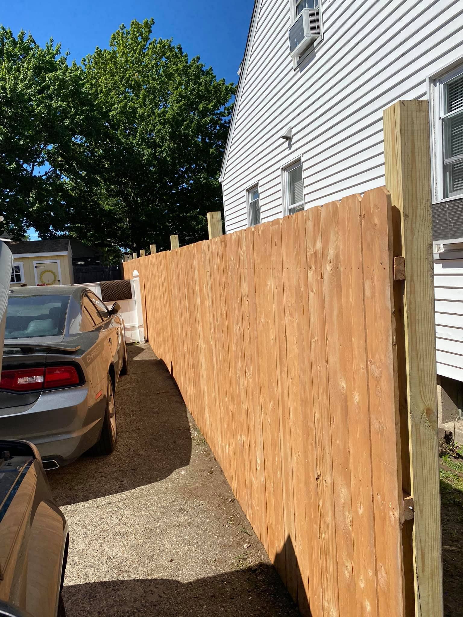 a wooden fence is being built in front of a house .