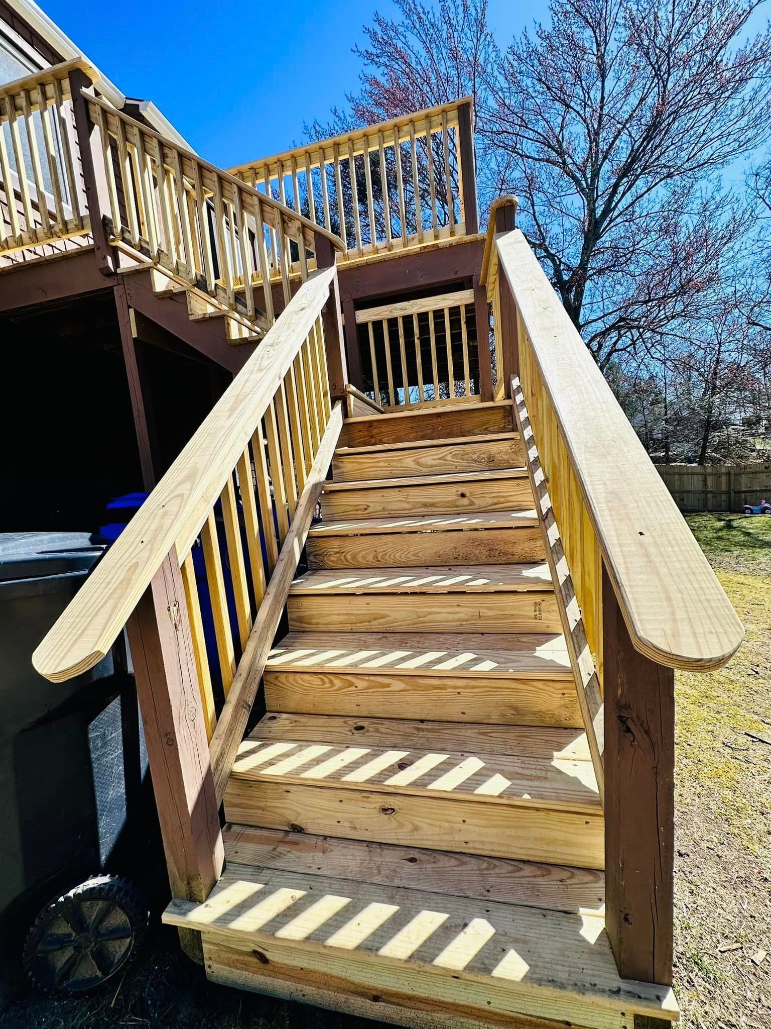 a wooden deck with stairs leading up to it .