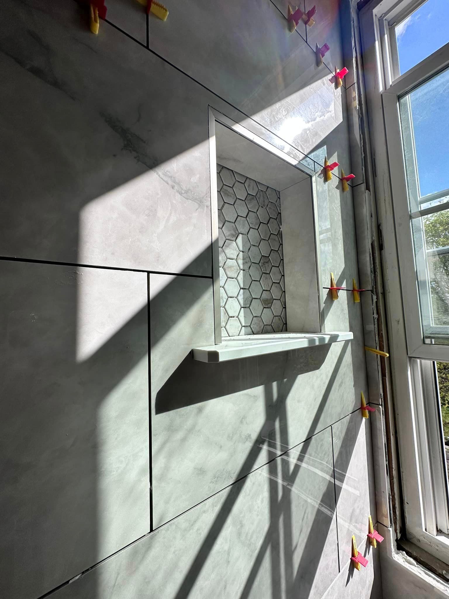 the sun is shining through the window and casting a shadow on the wall .