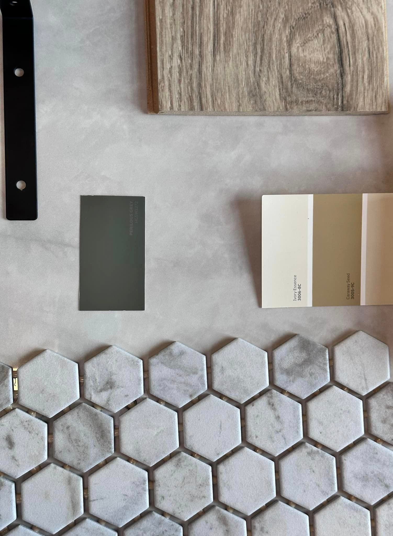 a selection of tiles , wood , and paint samples on a table .