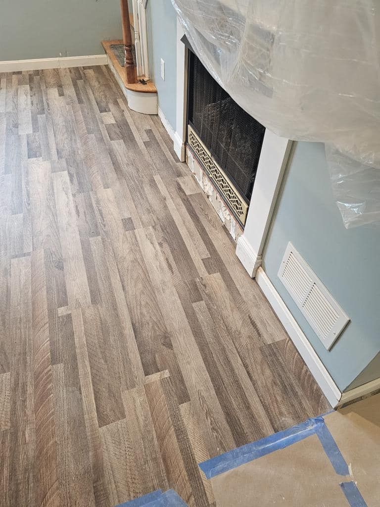 a living room with hardwood floors and a fireplace .