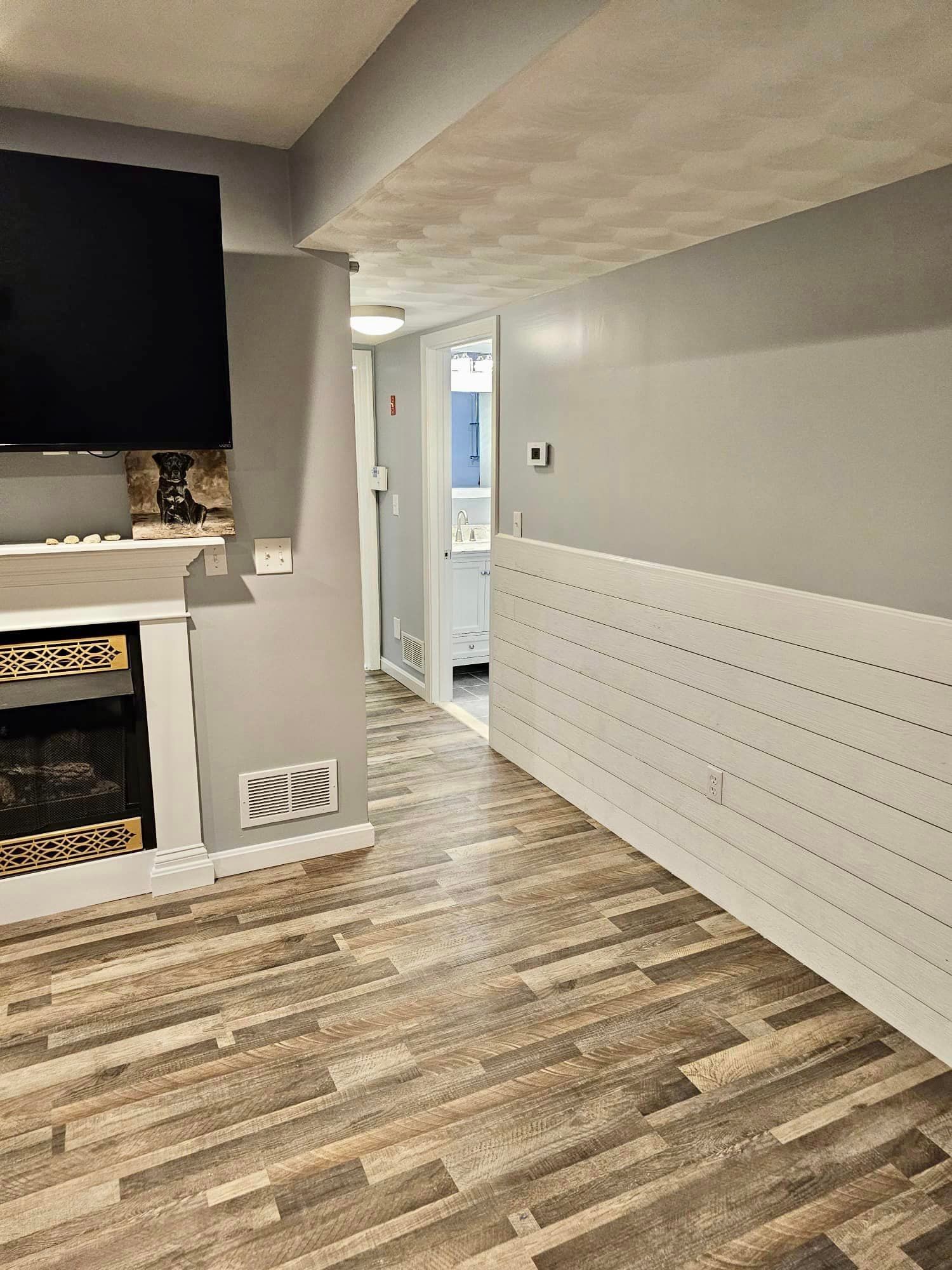 a living room with a fireplace and a flat screen tv .