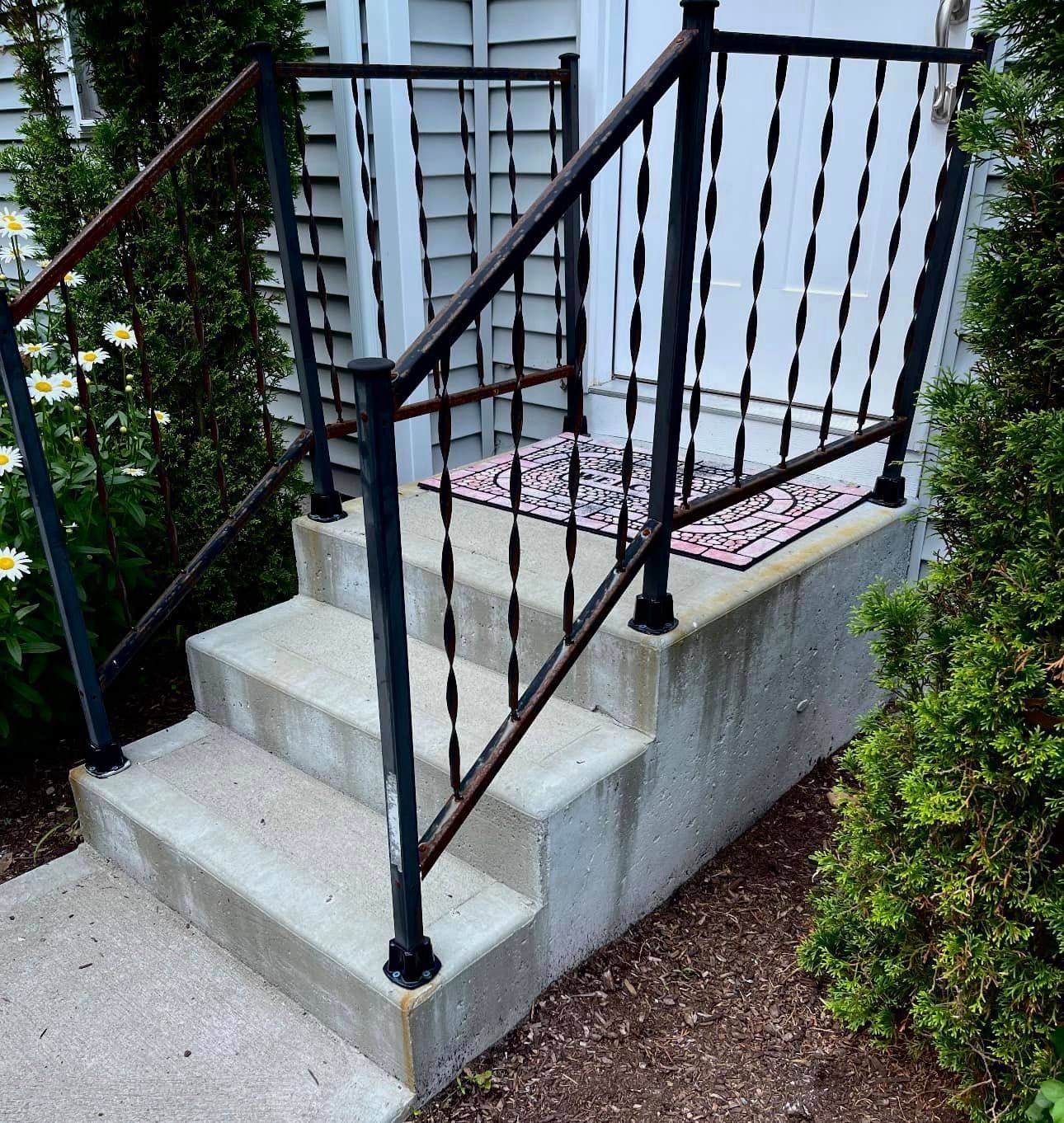 a set of stairs with a wrought iron railing