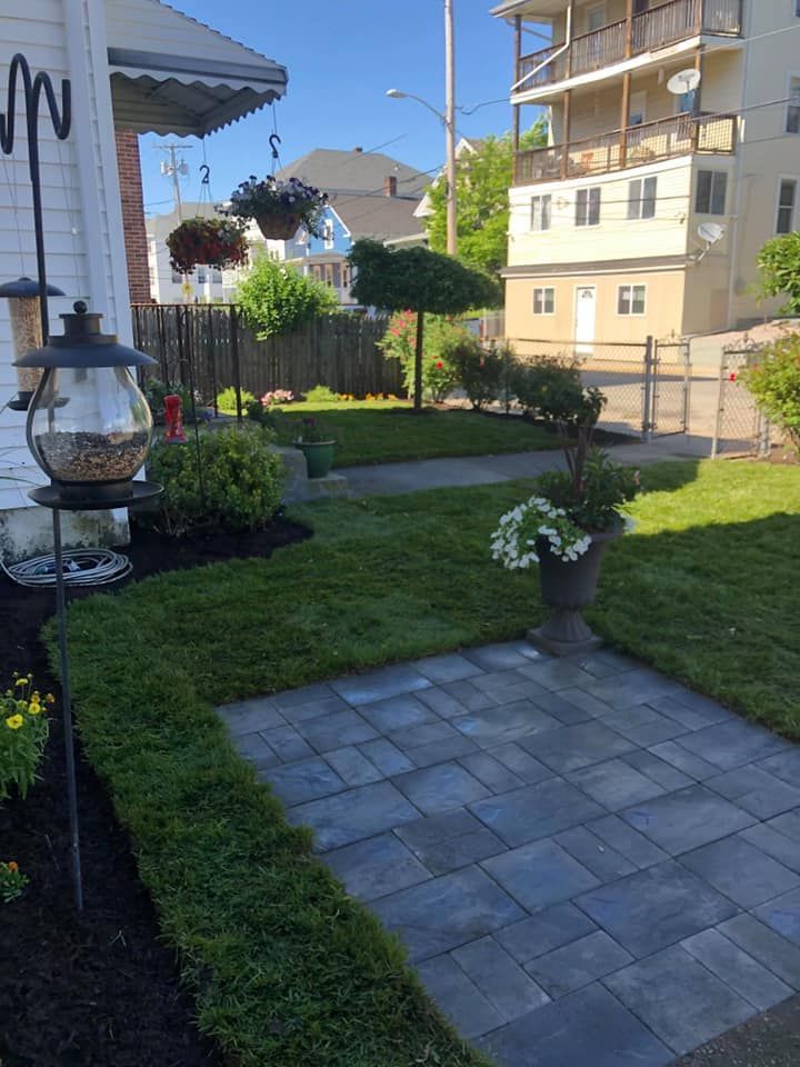 there is a bird feeder in the backyard of a house .