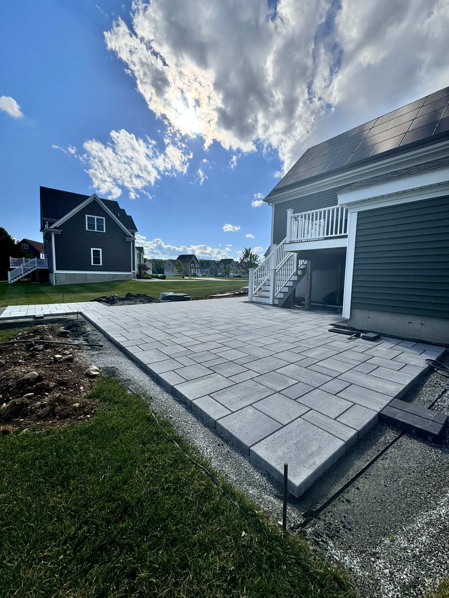 A patio is being built in front of a house