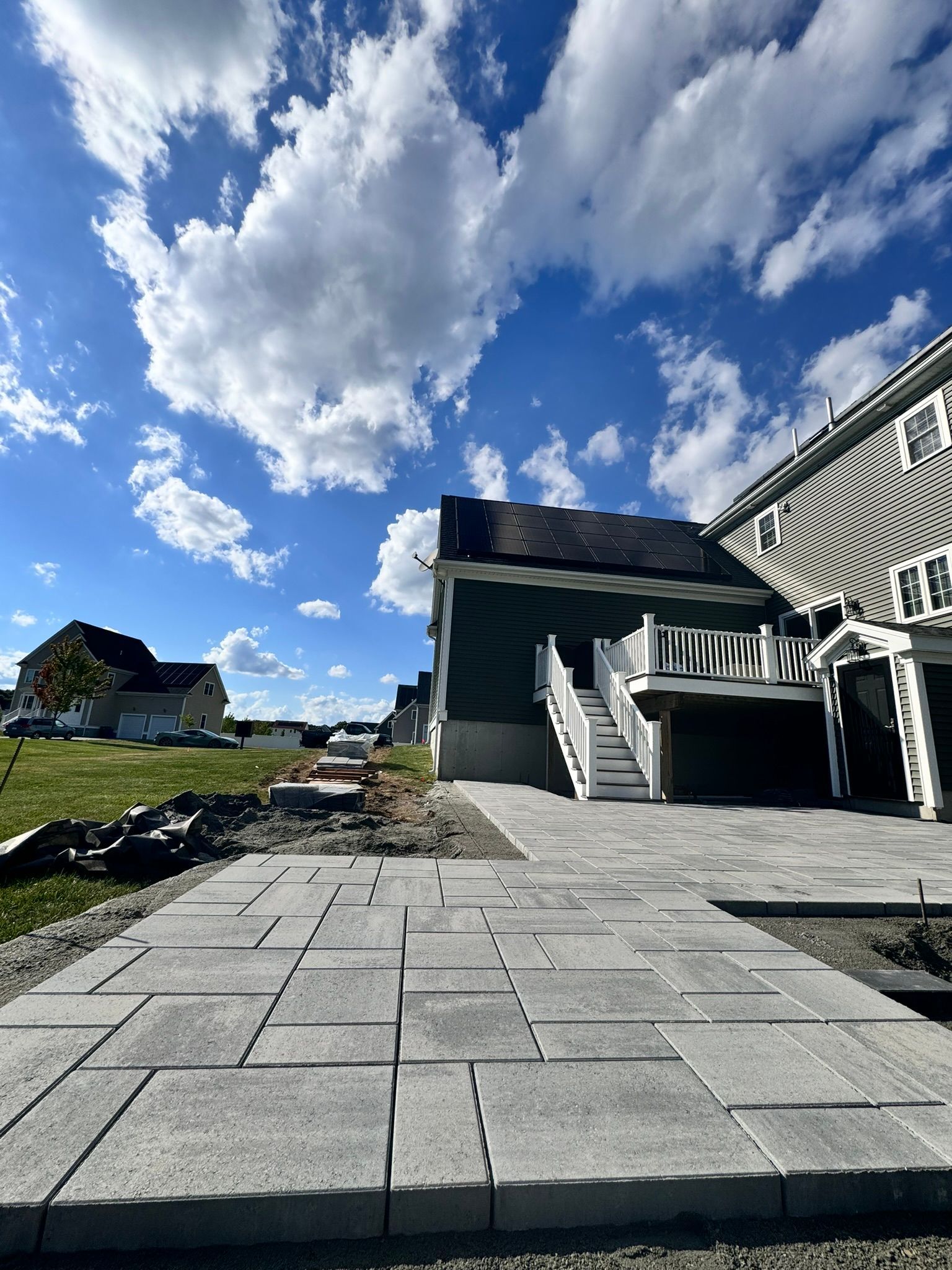 A large house with a patio and stairs in front of it