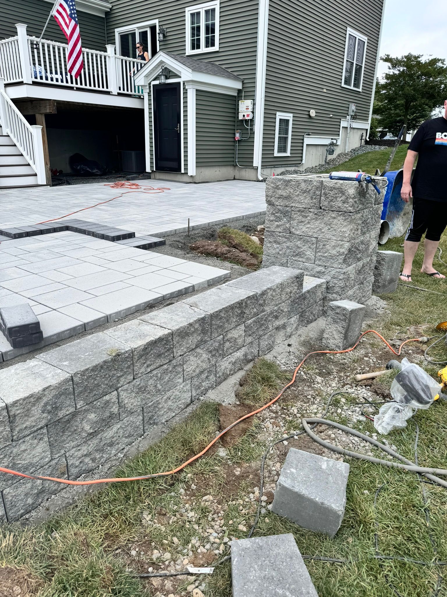 A man is standing in front of a house