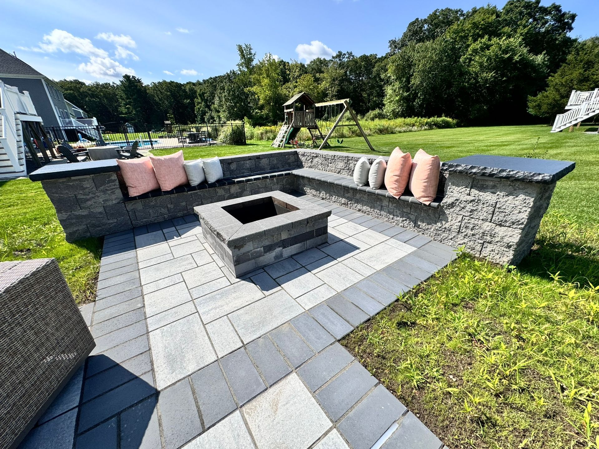 There is a fire pit in the middle of the patio