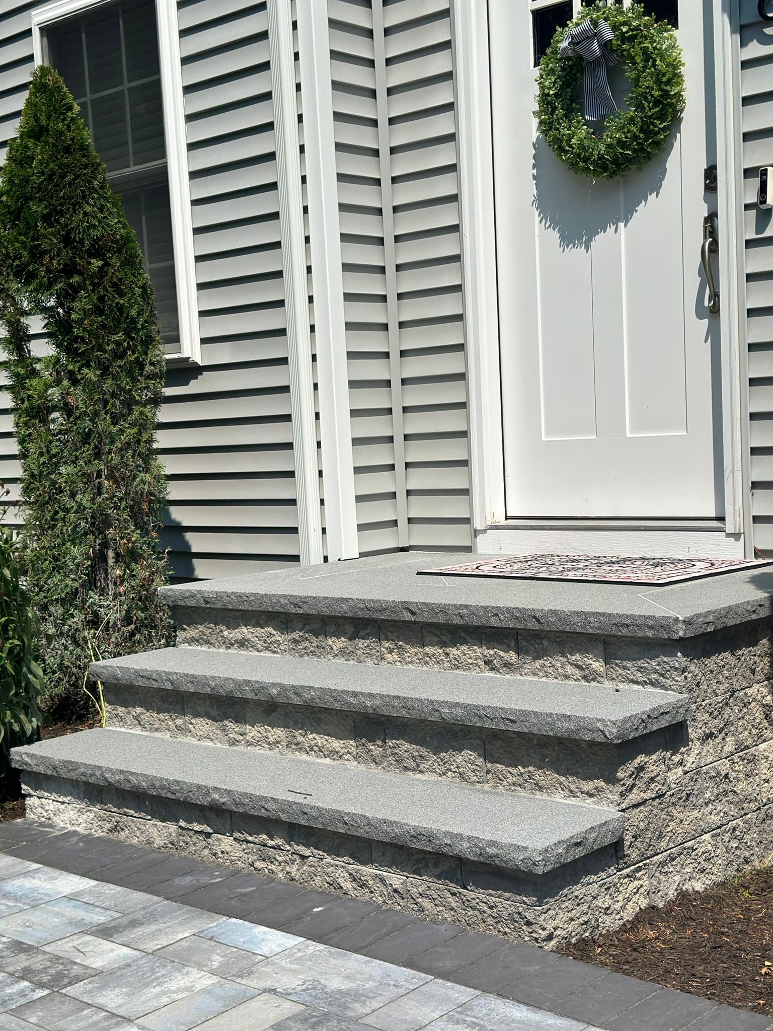 The front door of a house with a wreath on it
