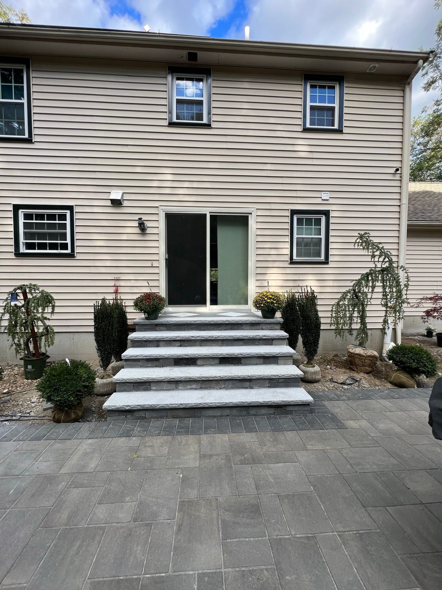 A house with stairs leading up to the front door.