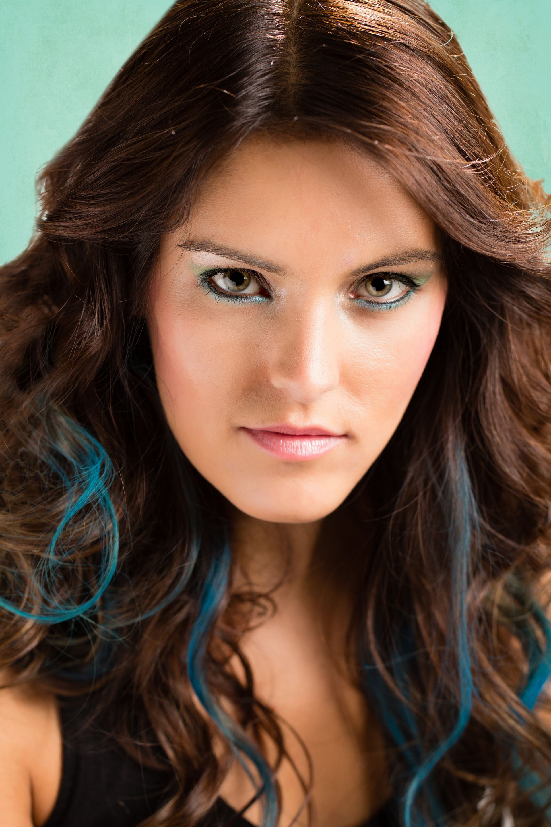 A woman with long brown hair and blue streaks