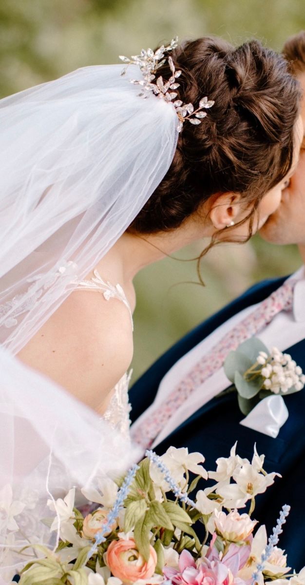 a bride and groom kissing on their wedding day