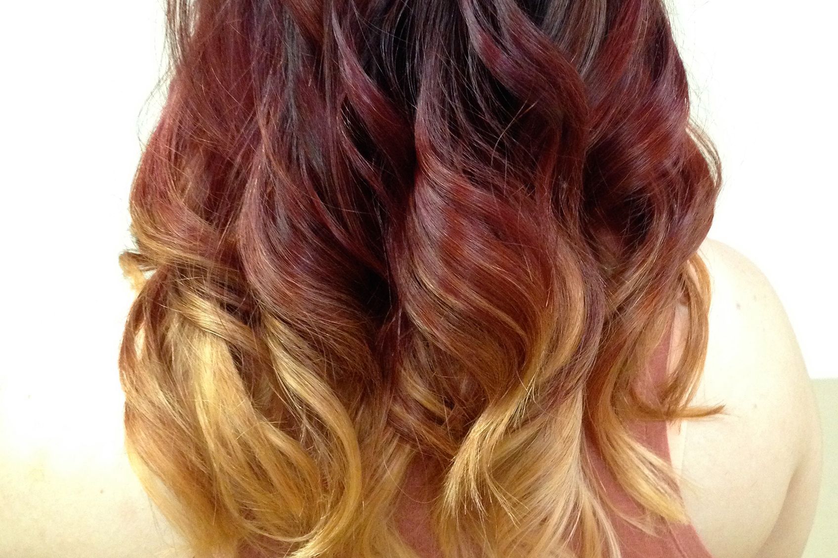 the back of a woman's head with red and blonde hair