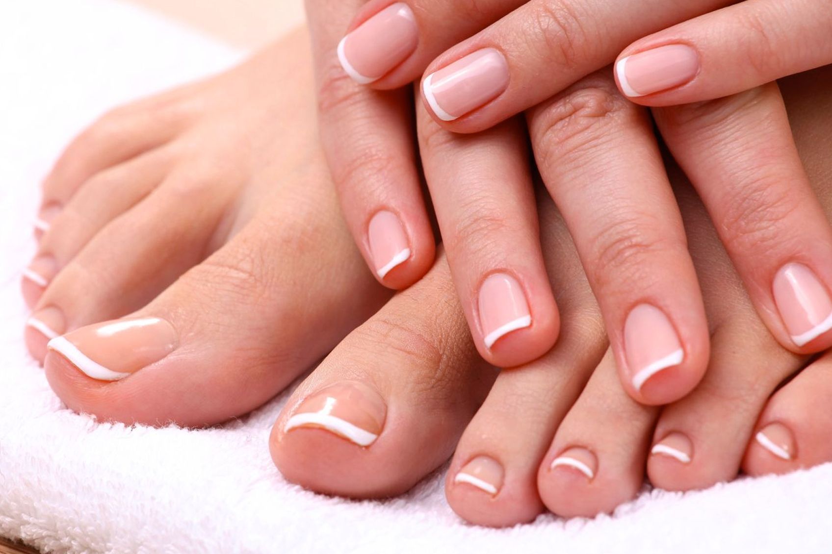 a close-up of a woman's hands and feet on a towel