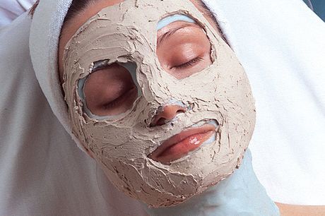 a woman is wearing a clay mask on her face
