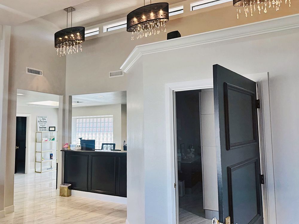 A large room with a black door and a black counter