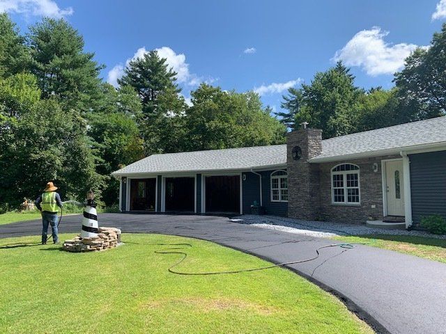 three garage with asphalt driveway
