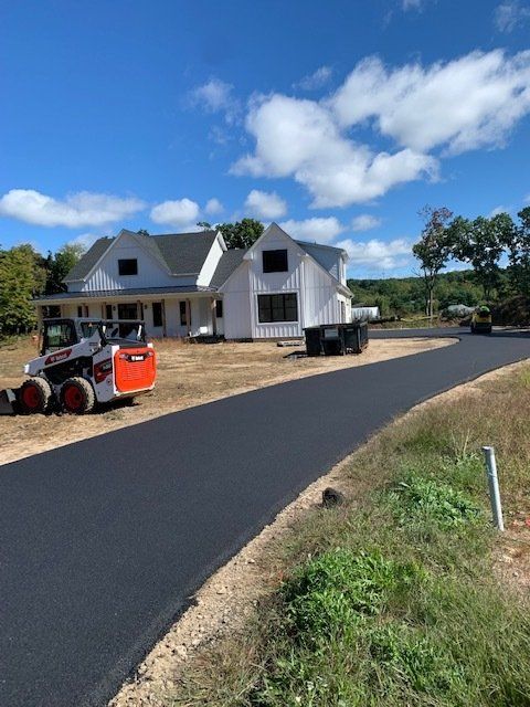 white house with asphalt driveway