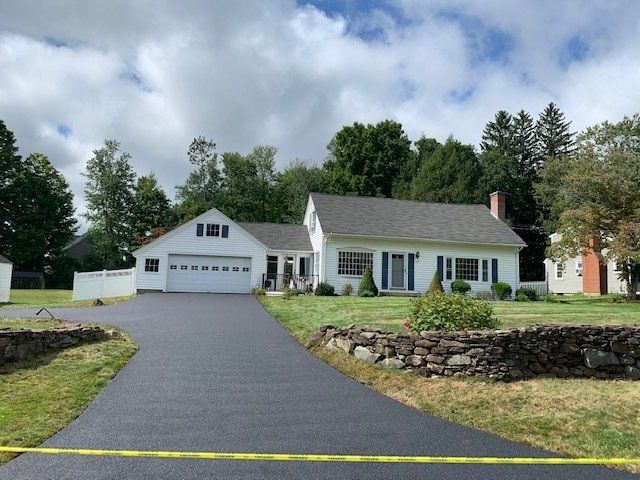 house with wide asphalt driveway