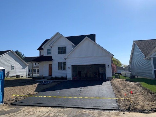 White house with asphalt driveway