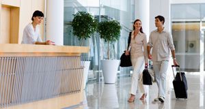 Couple with baggage checking in a hotel