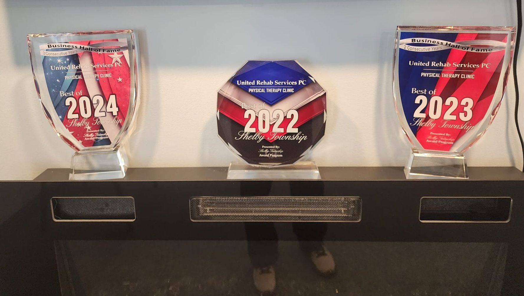 Three trophies are sitting on a table