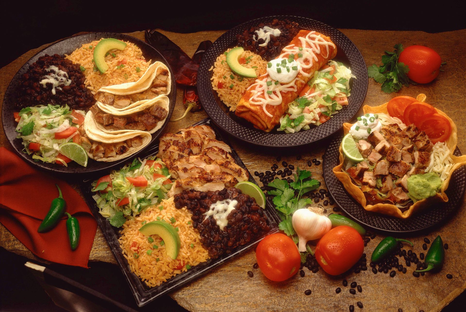 A table full of different plates of food.