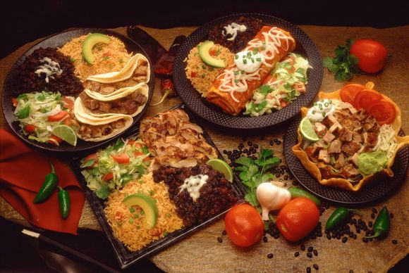 A table full of different plates of food.