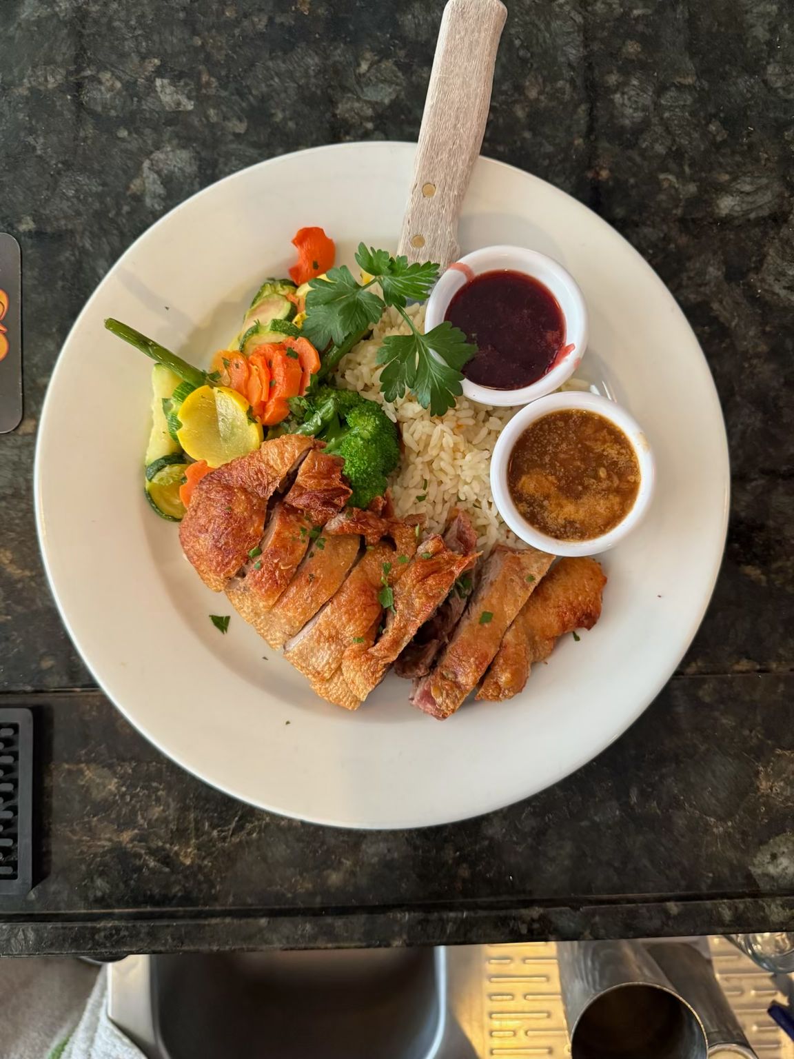 A plate of food with meat and vegetables on a table