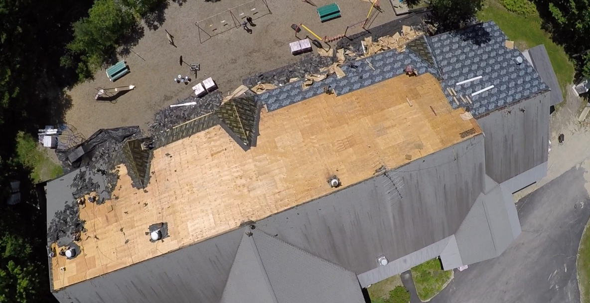 A wooden roof is being installed on a house.