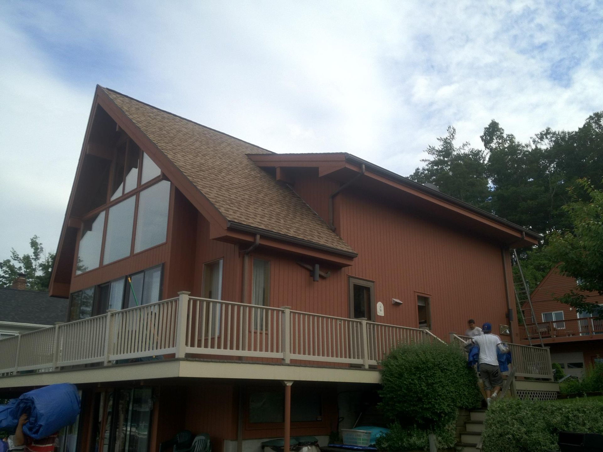A large house with a large deck and stairs