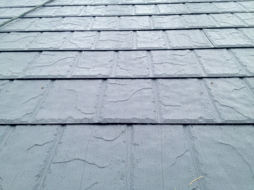 A close up of a roof with slate tiles on it.