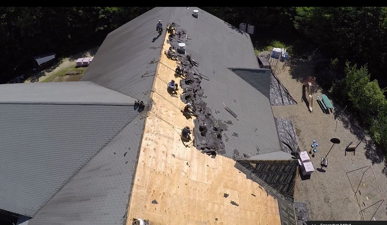An aerial view of a roof that is being repaired