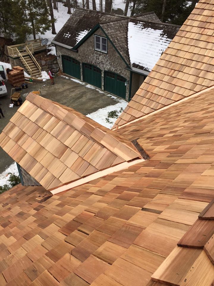 A wooden roof is being installed on a house.