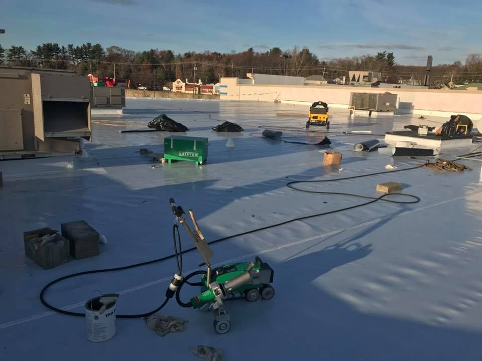 A white roof is being installed on a building.
