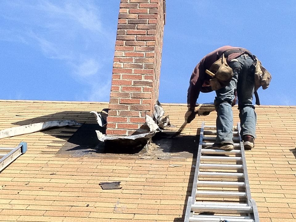 A man is working on a roof with a ladder