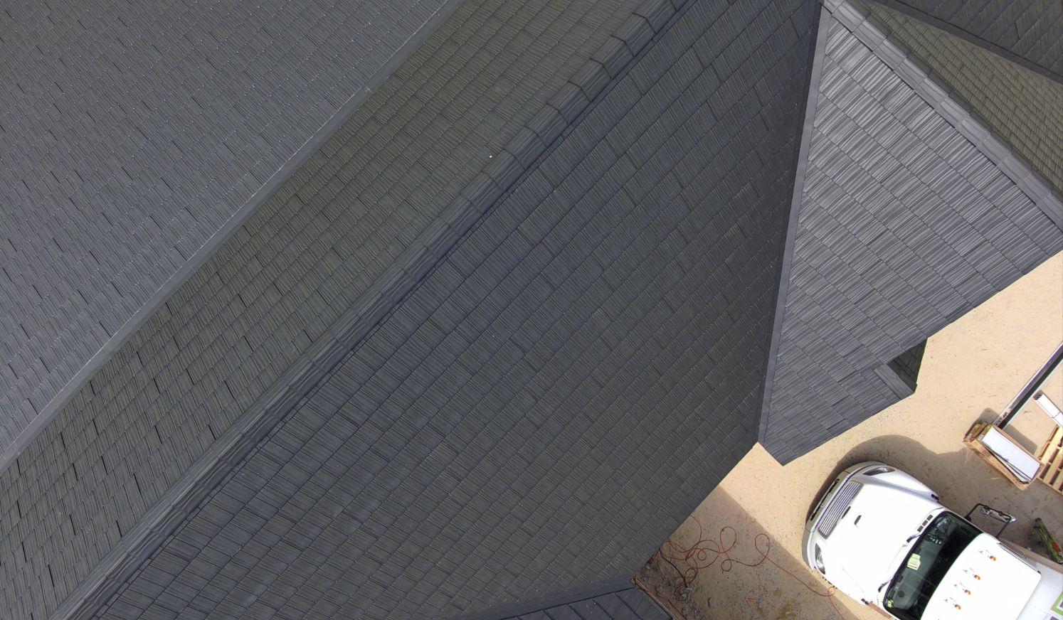 An aerial view of a building with a car parked in front of it