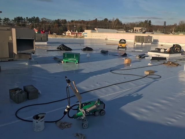 A white roof is being installed on a building.