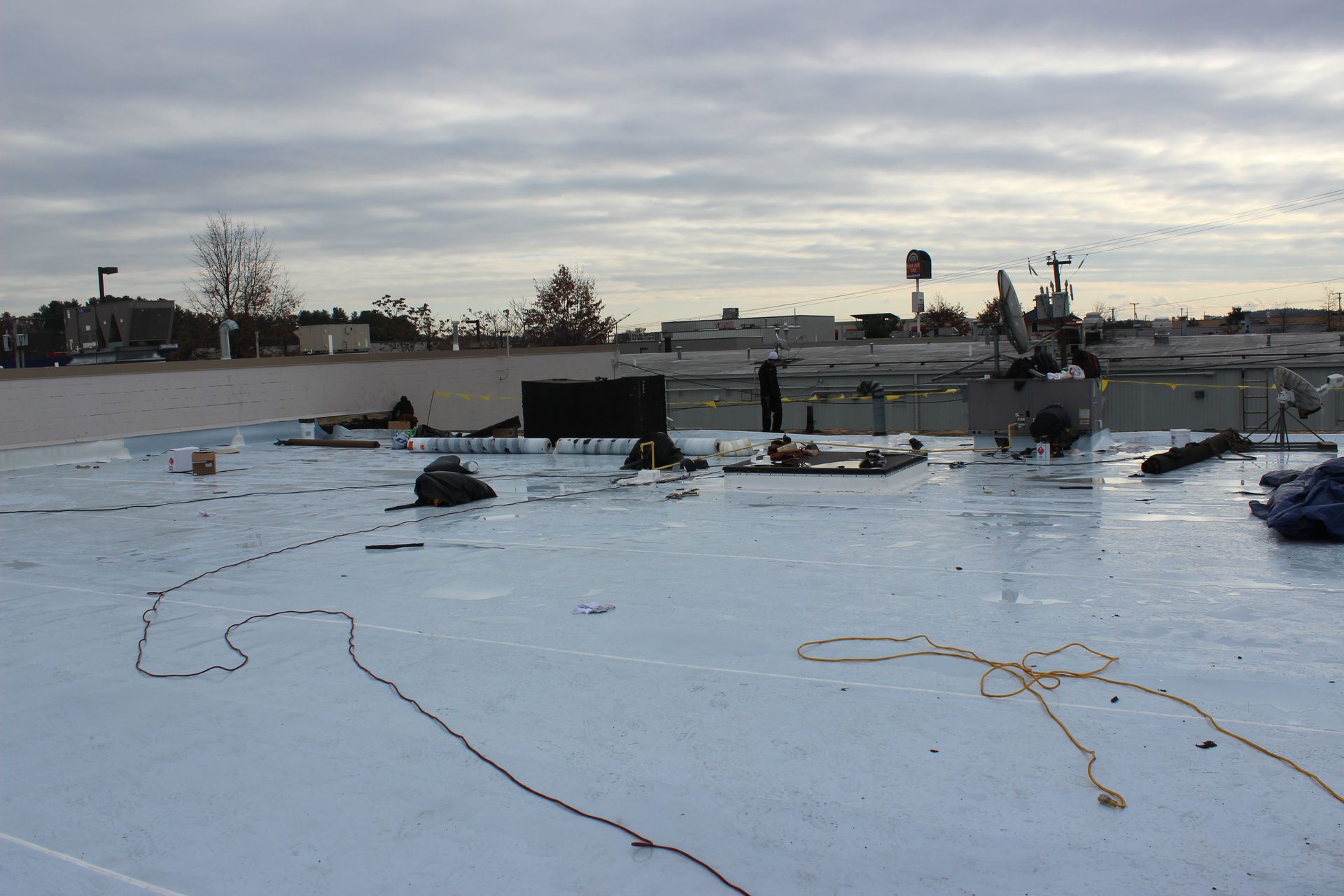 A white roof with a lot of wires on it