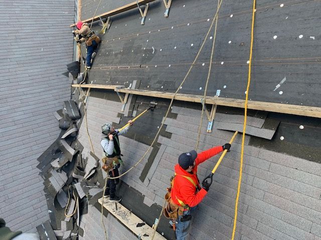 A group of men are working on the side of a building