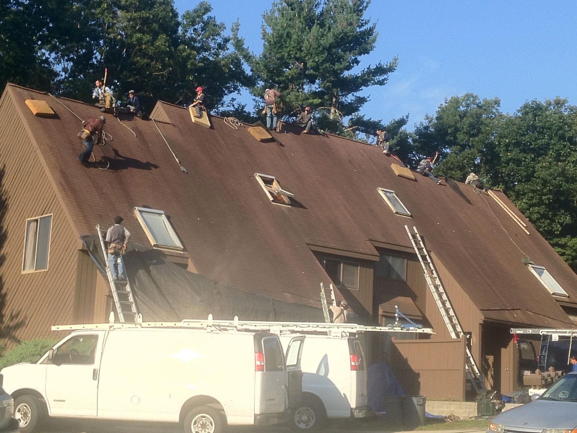 A group of people are working on the roof of a building