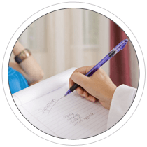 A counselor writing a notes on her notepad