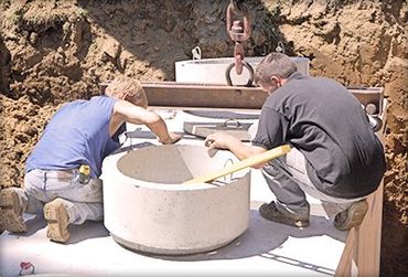 Men working on septic tank installation