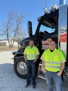 Tim and Taylor are standing near the truck.