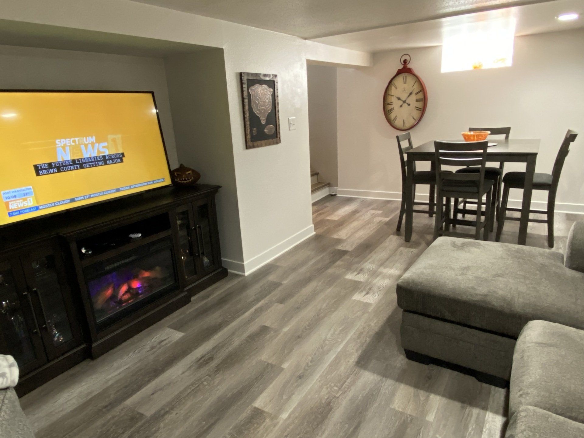 A living room with a fireplace , couch , table and chairs.