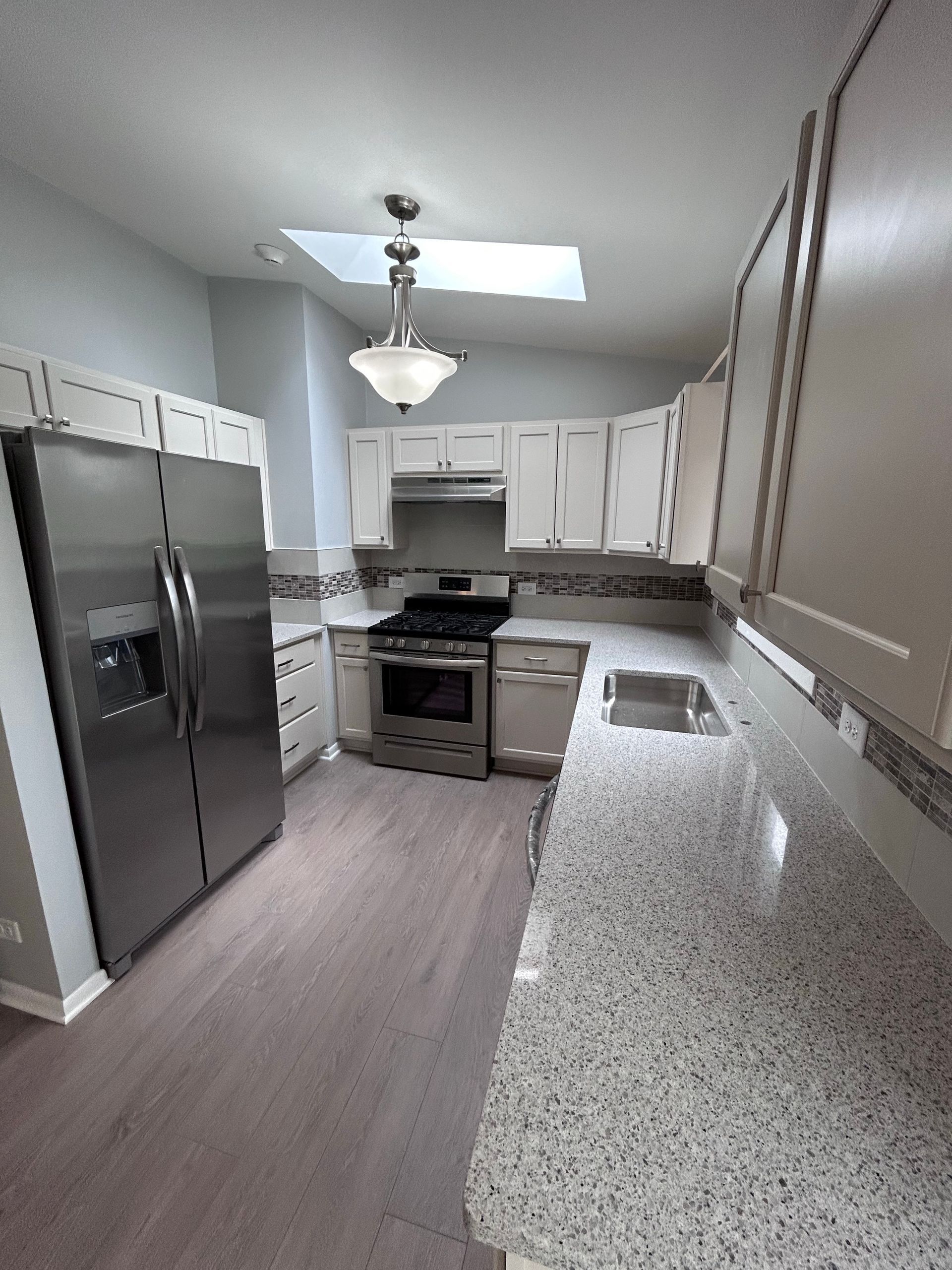 A kitchen with stainless steel appliances and granite counter tops