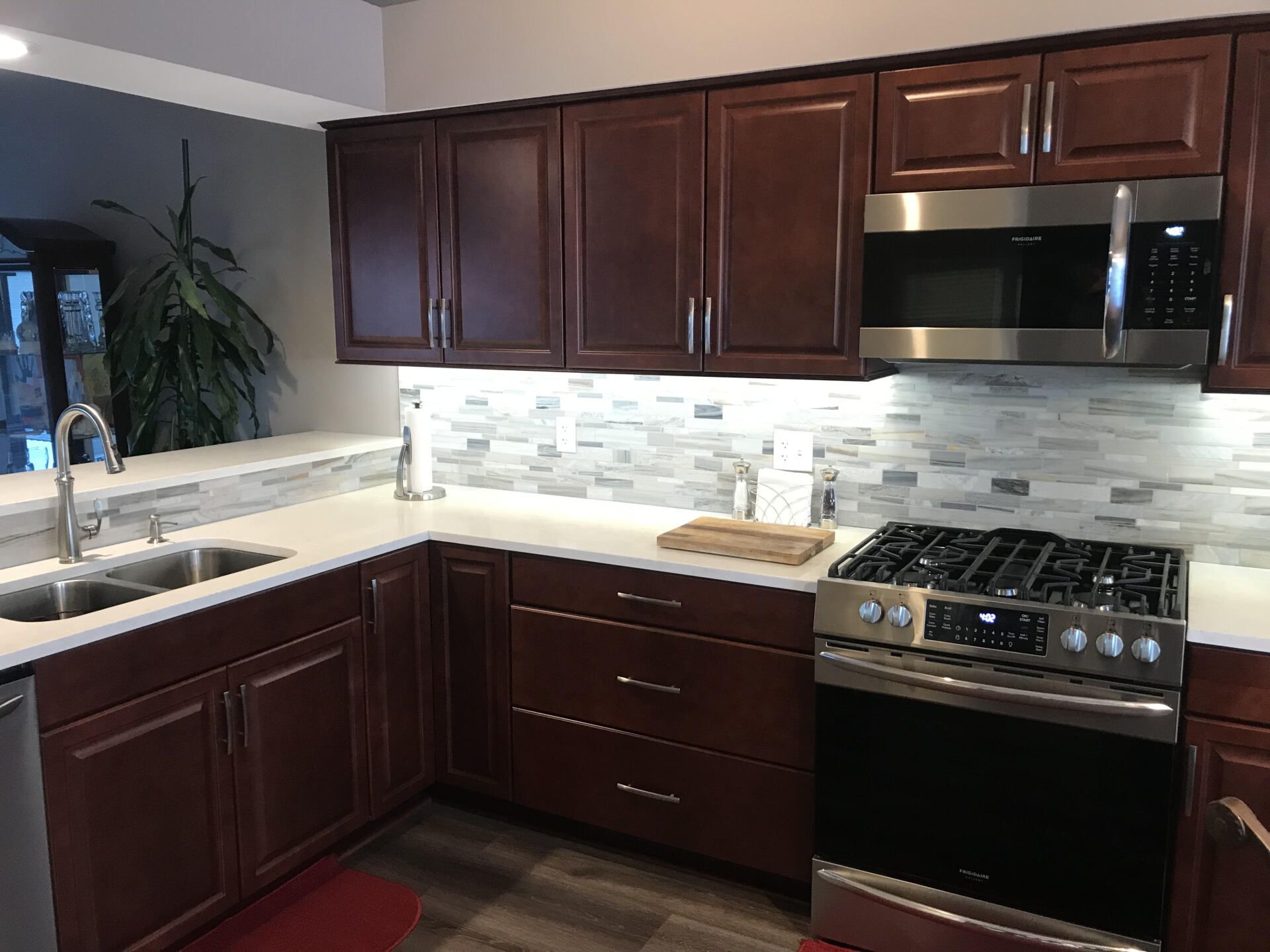 A kitchen with stainless steel appliances and wooden cabinets.