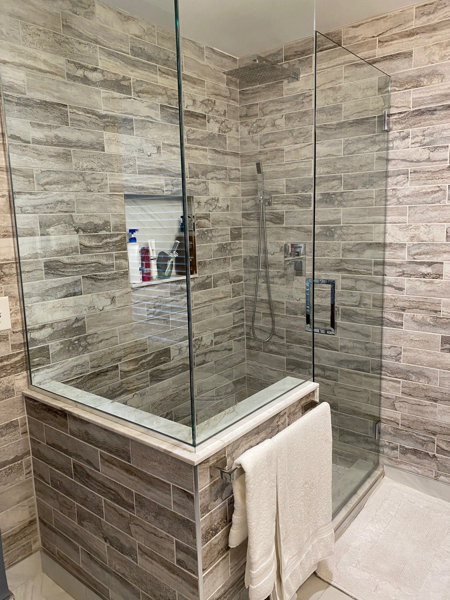 A bathroom with a walk in shower and a bathtub.