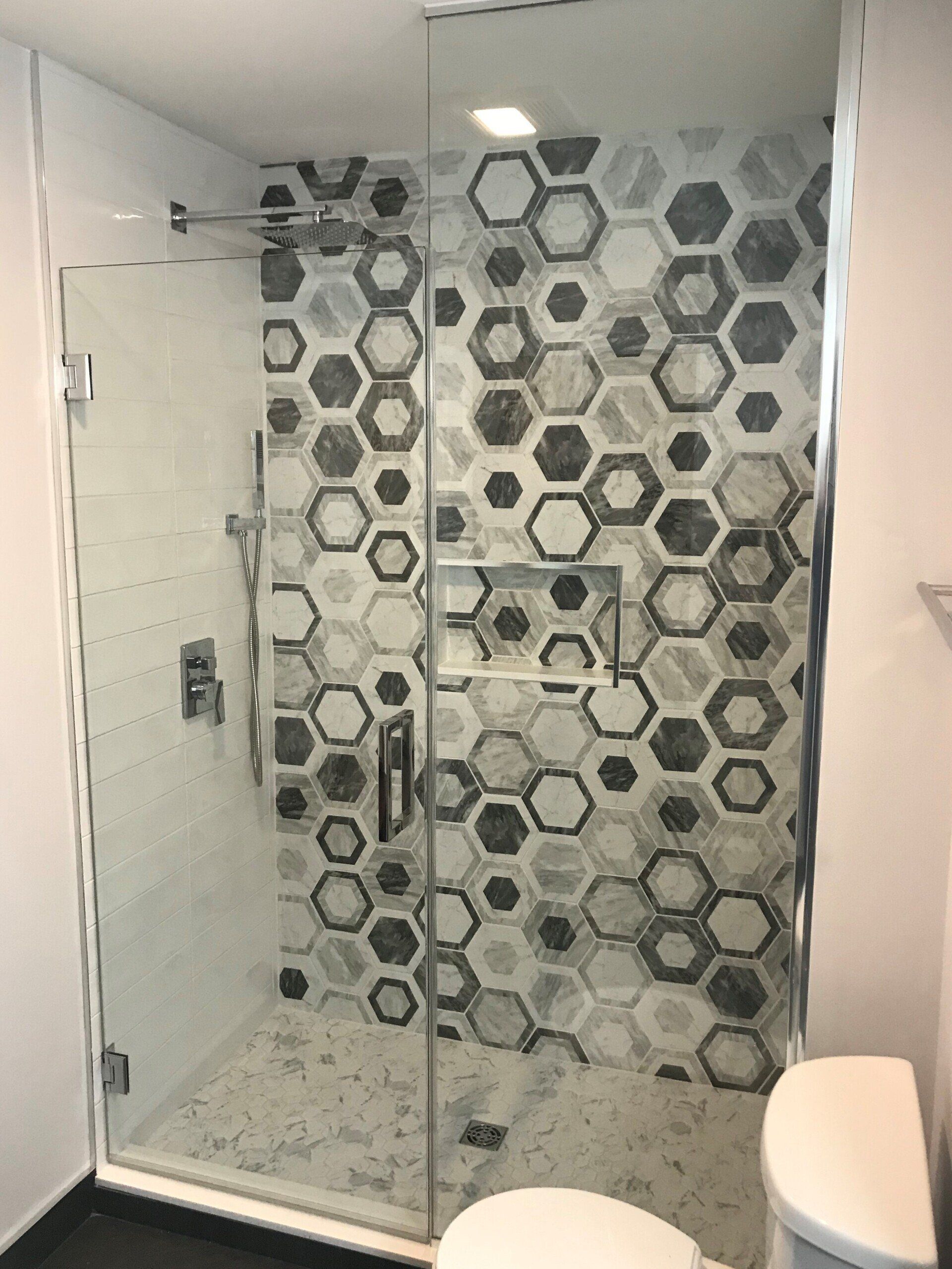 A bathroom with a walk in shower and a toilet