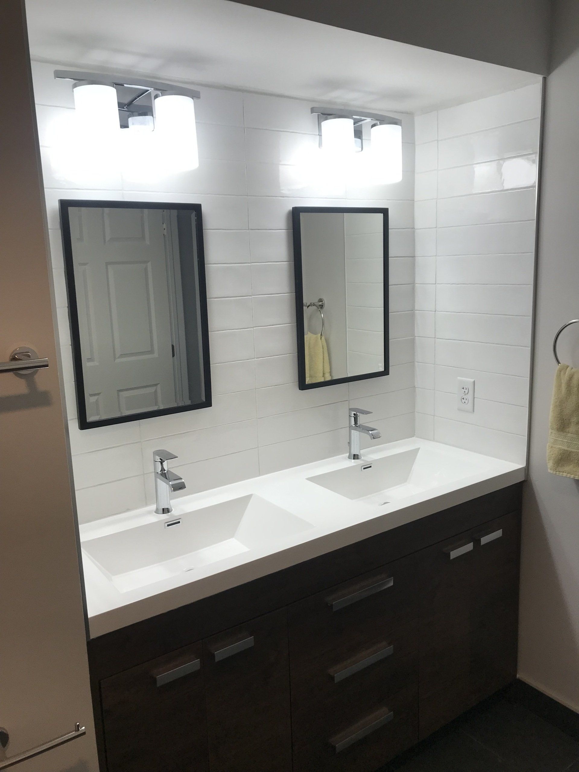 A bathroom with two sinks and two mirrors